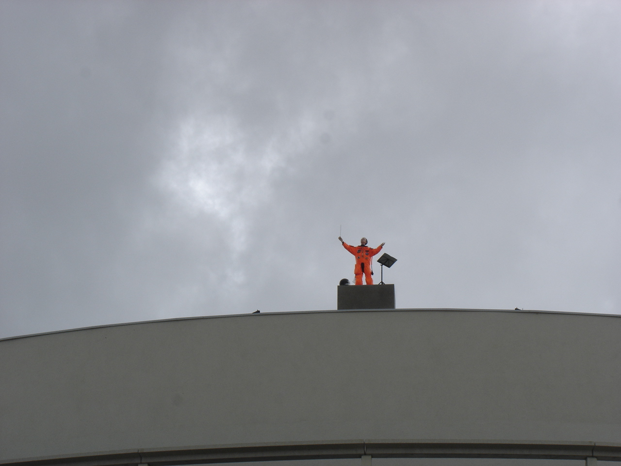 Een pop in een oranje overal, een kunstwerk van Jan Fabre, dat is geplaatst op het dak van het Casino Kursaal in Oostende (België).